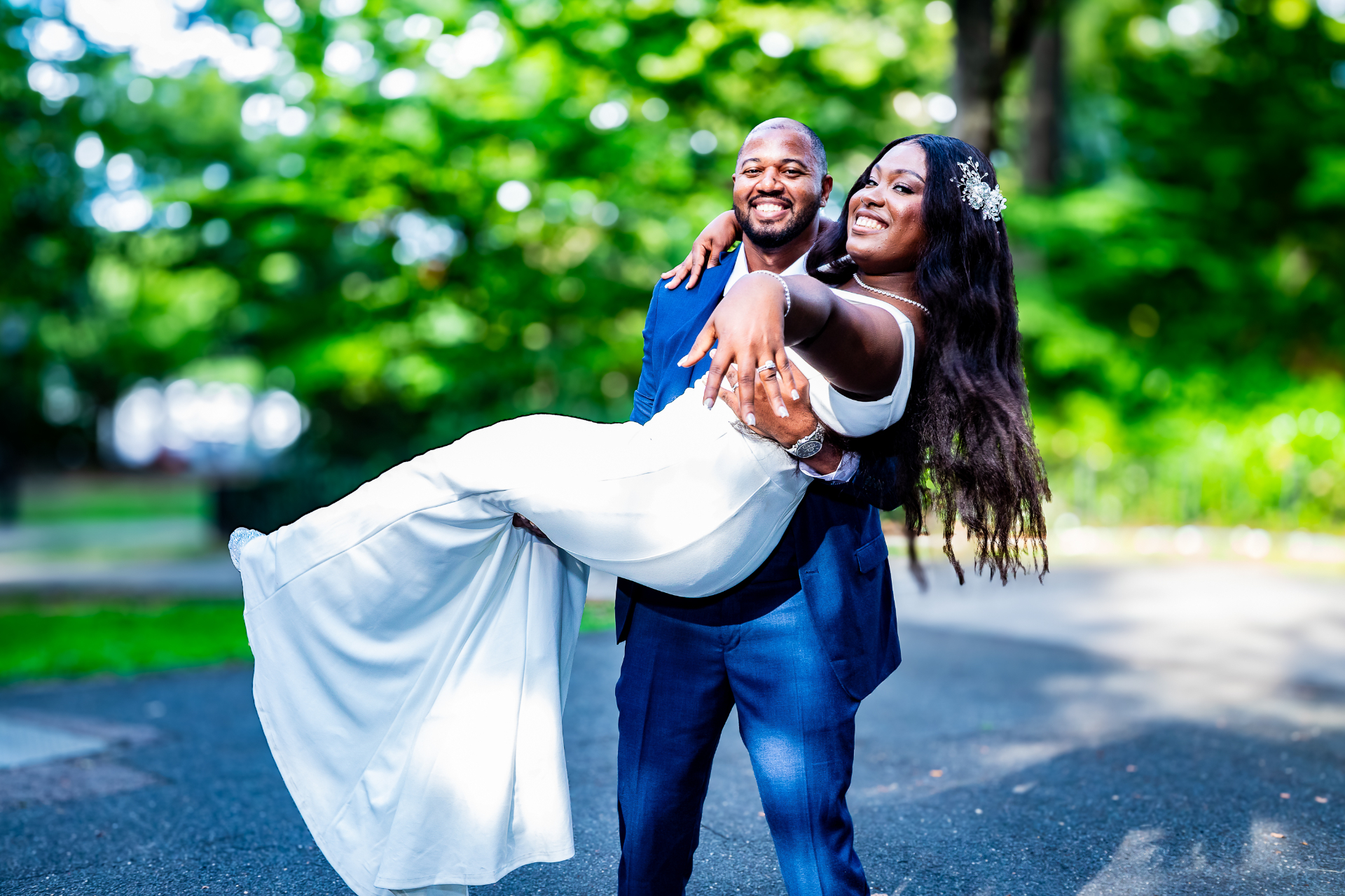 Groom carrying bride in park